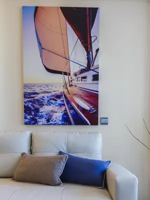 a painting of a sailboat on the wall above a couch at HORIZONTE Sunny Home by Cadiz4Rentals in Cádiz