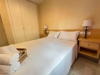 a living room with a couch and a flat screen tv at Novo Sancti Petri Atardecer Planta baja in Chiclana de la Frontera