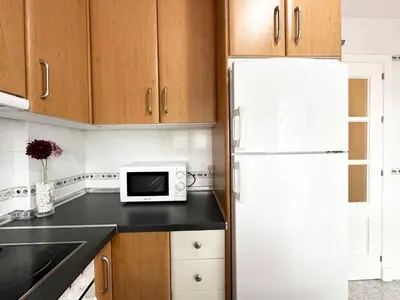a kitchen with a sink and a washing machine at Novo Sancti Petri Atardecer Planta baja in Chiclana de la Frontera