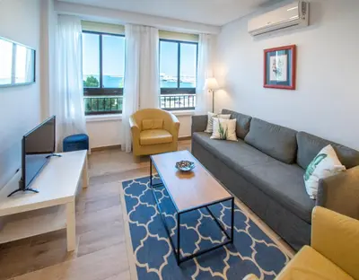 a living room with a couch and a tv at Apartamento Albatro´s suite in Cádiz