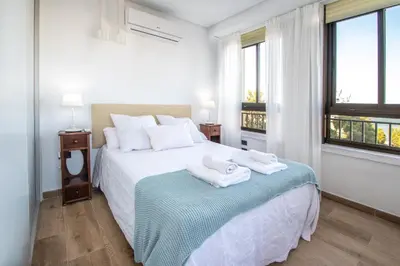 a bedroom with a bed with two towels on it at Apartamento Albatro´s suite in Cádiz