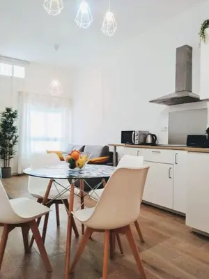 a kitchen with a table and chairs in a kitchen at Los Patios de la Caleta in Cádiz
