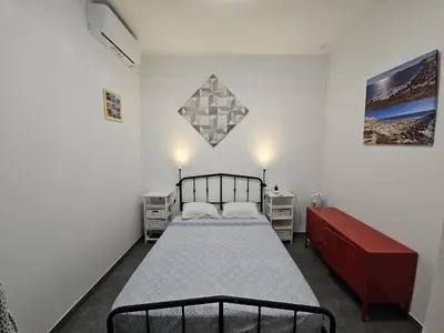 a bedroom with a bed and two night stands at Sopranis del MAR Apartamento centro Cádiz, junto playa y estación in Cádiz