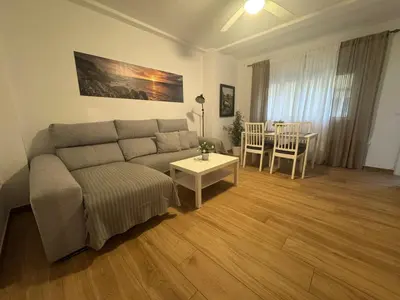 a living room with a couch and a table at Tu Rincón Gaditano PLAYA y WIFI Grupo AC Gestion in Cádiz