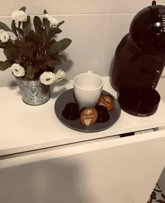 a counter with a coffee maker and a cup and cookies at Tu Rincón Gaditano PLAYA y WIFI Grupo AC Gestion in Cádiz