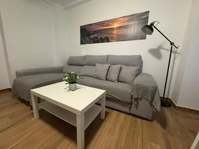 a living room with a couch and a table at Tu Rincón Gaditano PLAYA y WIFI Grupo AC Gestion in Cádiz