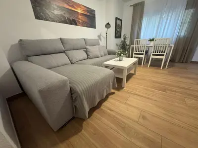 a living room with a couch and a table at Tu Rincón Gaditano PLAYA y WIFI Grupo AC Gestion in Cádiz