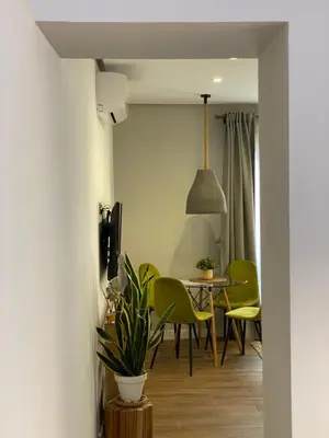 a dining room with green chairs and a table at Charito 18 in Cádiz