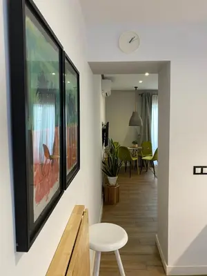 a living room with a bench and a painting on the wall at Charito 18 in Cádiz