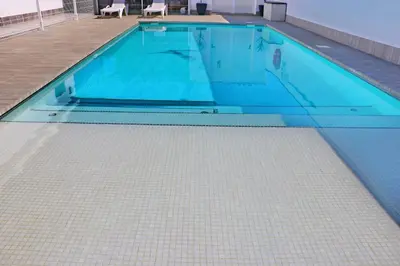 a swimming pool with a tiled floor at Chalet moderno con pisicina in Conil de la Frontera