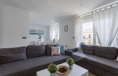 a living room with a gray couch and a table at Luxe Vista Histórico 5 rooms 4 baños in Jerez de la Frontera