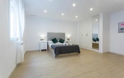 a bedroom with a bed and a large mirror at Luxe Vista Histórico 5 rooms 4 baños in Jerez de la Frontera
