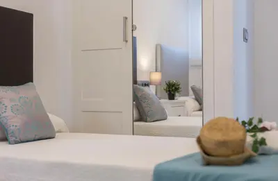 a bedroom with a mirror and a bed and a mirror at Luxe Vista Histórico 5 rooms 4 baños in Jerez de la Frontera