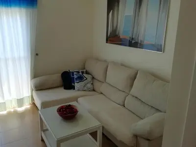 a living room with a couch and a table at Apartamento en rota in Rota