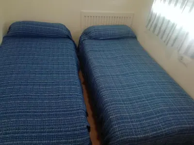 two blue pillows sitting next to each other in a room at Apartamento en rota in Rota