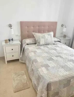 a bedroom with a large bed with two night stands at Apartamento Felisa in Arcos de la Frontera