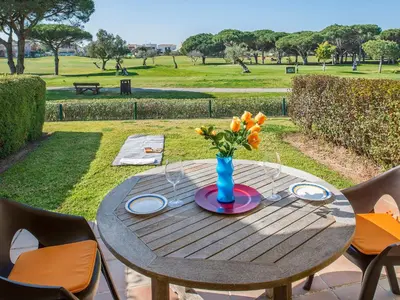 a wooden table with a vase of flowers on it at Holiday Home Brisamar - Novo Sancti Petri by Interhome in Chiclana de la Frontera