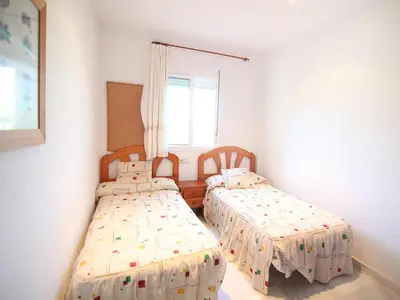 a bedroom with two beds and a window at Holiday Home Brisamar - Novo Sancti Petri by Interhome in Chiclana de la Frontera