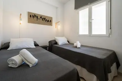 two beds sitting next to each other in a room at Cádiz Beach & Kids - free parking - sea views in Cádiz