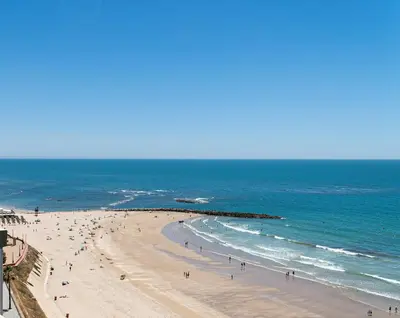 a group of people on a beach with the ocean at Cádiz Beach & Kids - free parking - sea views in Cádiz
