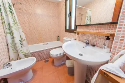 a bathroom with a sink and a toilet and a mirror at Apartamento Centro Jerez in Jerez de la Frontera
