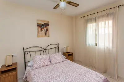 a bedroom with a bed and a ceiling fan at Apartamento Centro Jerez in Jerez de la Frontera