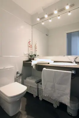 a bathroom with a toilet and a sink and a mirror at Apartamento Playa Victoria Cadiz in Cádiz
