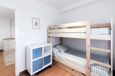 a bedroom with two bunk beds and a desk at Apartamento La Terraza del Mar in Cádiz