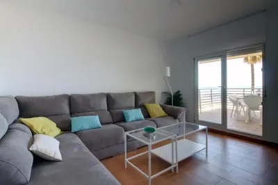 a living room with a gray couch and a table at Apartamento La Terraza del Mar in Cádiz