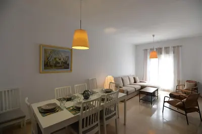 a living room with a table and a couch at PLAZA ALFONSO SÁNCHEZ FERRAJÓN in Jerez de la Frontera
