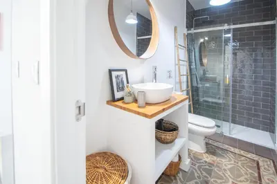 a bathroom with a sink and a toilet and a mirror at Apartamentos Las Musas de Cadiz in Cádiz