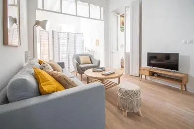 a living room with a couch and a table at Apartamentos Las Musas de Cadiz in Cádiz