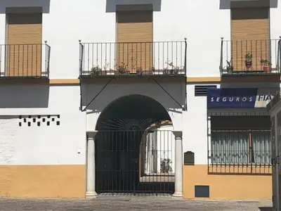 a building with a black gate and a balcony at El Rincon de Elena (Garden Apartment) in Jerez de la Frontera