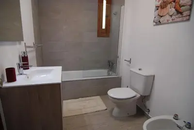 a bathroom with a toilet and a sink and a tub at El Rincon de Elena (Garden Apartment) in Jerez de la Frontera