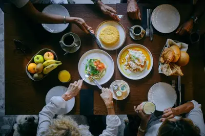 a group of people sitting around a table eating food at Boutique Hotel OLOM - Only Adults recommended in Cádiz