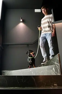 a young man standing on top of a room with a dog at Boutique Hotel OLOM - Only Adults recommended in Cádiz