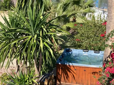 a hot tub in a garden with trees and plants at El Lagar de los Abuelos in Arcos de la Frontera