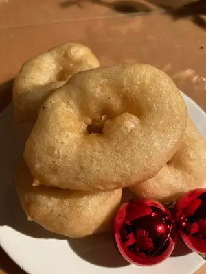 two donuts on a plate next to two cherries at El Lagar de los Abuelos in Arcos de la Frontera