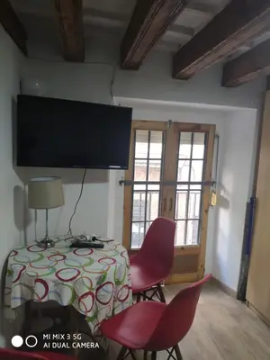 a room with a table and chairs and a flat screen tv at Cathedral two bedroom unit & two balconies in Cádiz