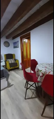 a living room with a table and chairs and a couch at Cathedral two bedroom unit & two balconies in Cádiz