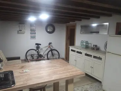 a kitchen with a table and a bike on the wall at Cathedral two bedroom unit & two balconies in Cádiz