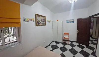 a room with a black and white checkered floor at A 50 metros de la playa in Cádiz