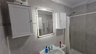 a bathroom with a sink and a mirror and a shower at A 50 metros de la playa in Cádiz