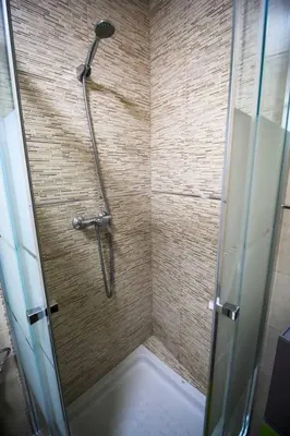 a shower with a glass door in a bathroom at SH Cruz. Moderno apartmento cerca del Mercado. in Cádiz