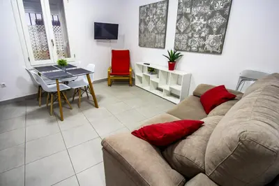 a living room with a couch and a table at SH Cruz. Moderno apartmento cerca del Mercado. in Cádiz