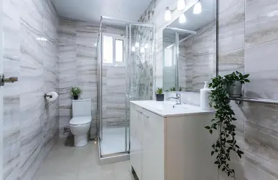 a bathroom with a toilet and a shower and a sink at El Balneario in Cádiz
