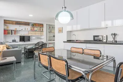 a living room with a table and some chairs at Sherryflat Casa del Arquitecto in Jerez de la Frontera