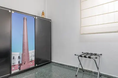 an empty room with a large window with an image of a factory at Sherryflat Casa del Arquitecto in Jerez de la Frontera