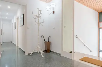 a hallway of an art gallery with a white wall at Sherryflat Casa del Arquitecto in Jerez de la Frontera