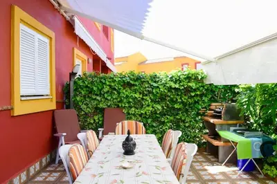 a table and chairs sitting on a patio at Charming house in Rota + garden in Rota